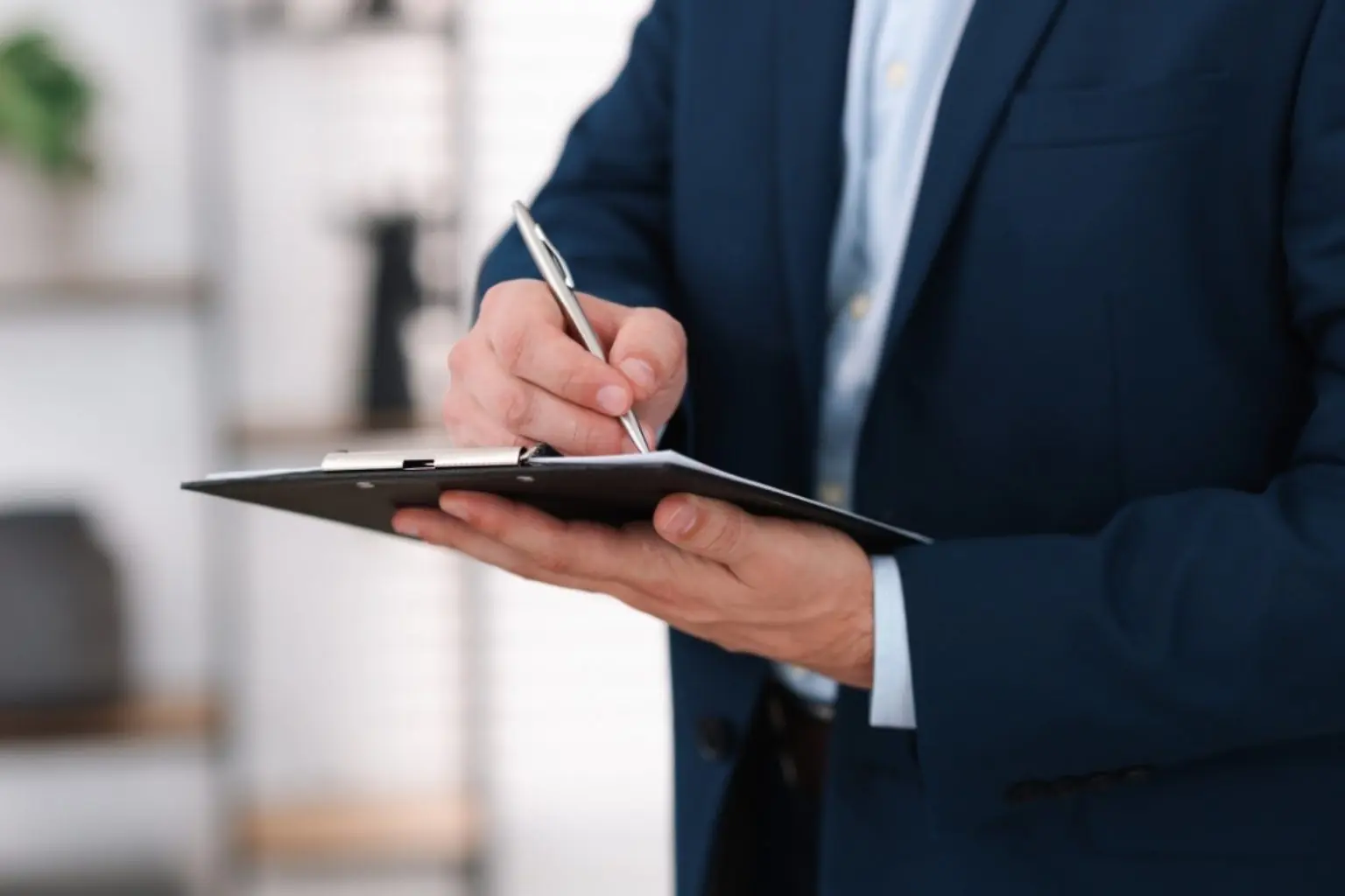 Professional conducting a home inspection, taking notes on a clipboard, emphasizing environmental safety and testing services.