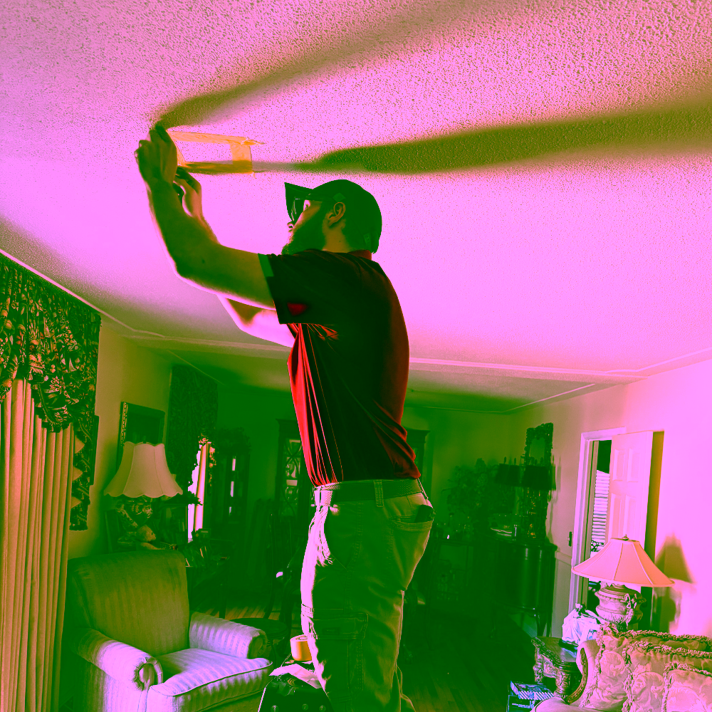 EnviroPro 360 asbestos inspector taking a popcorn ceiling sample for an asbestos survey.